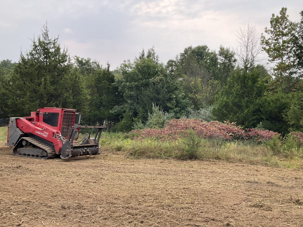 Mulching attachment on a large piece of equipment.